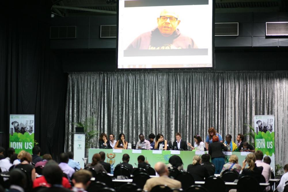 Delegates at the event watch UNESCO Goodwill Ambassador for Peace and Reconciliation, Forest Whitaker's call to action.