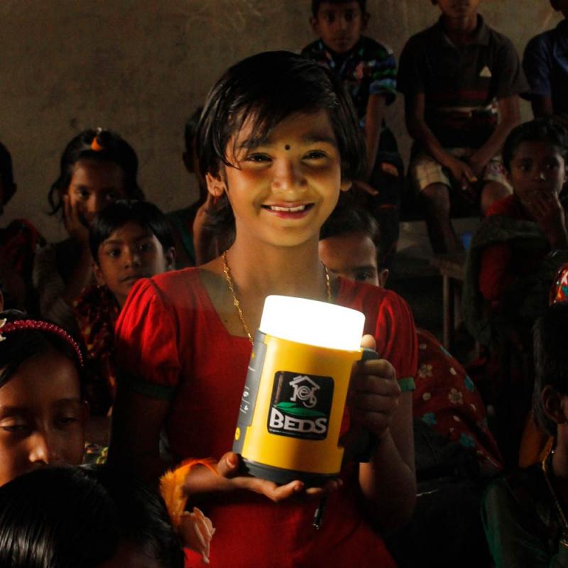 A child holds a solar lamp.