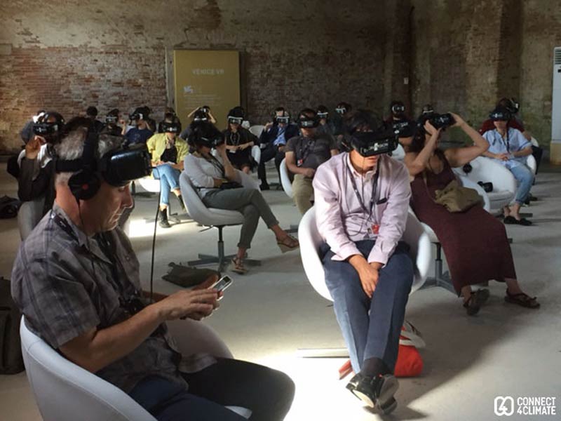 People watching videos at the VR Island at Venice Film Festival. Photo Credits: Francis James Dobbs/Connect4Climate