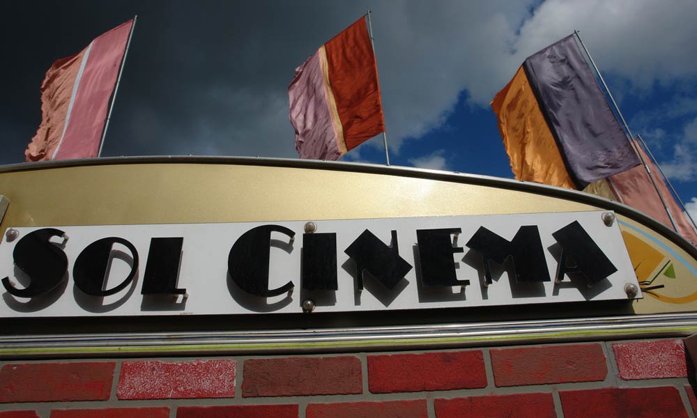 Sol Cinema, caravan, and flags. Photo Credit: Sol Cinema