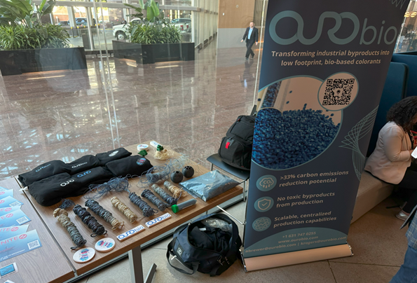 Ourobio materials laid out on a table next to an informational poster.