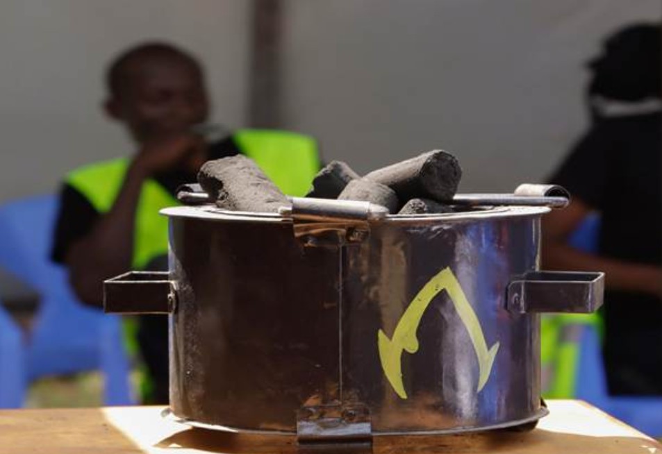 A stove with briquettes in it sits on a table.
